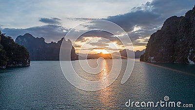 Boat trip on lake water of tropical lake, mountains, cliffs and rocks during sunset Stock Photo