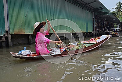 Boat vendor selling tropical fruits nearby floating market around Bangkok area Editorial Stock Photo