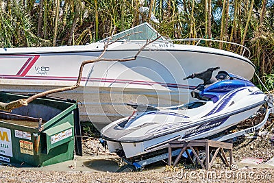 Boat and waverunner laying on the side of the road after Hurricane Ian Fort Myers FL Editorial Stock Photo