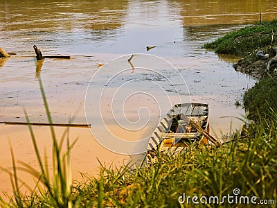 A boat wood at batanghari river side Stock Photo