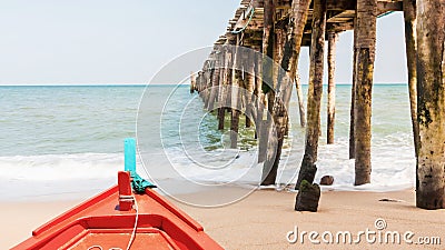 Boat and wood jetty at beach Stock Photo