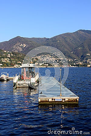 Boats along the coast in Lenno, Como lake, Italy. Beautiful touristic place Editorial Stock Photo