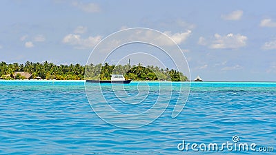 Boats anchored along tropical islands Stock Photo