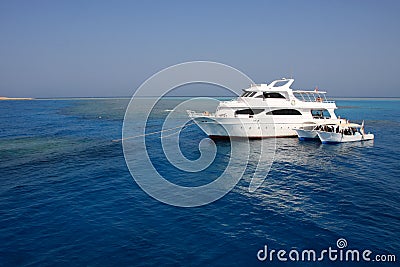 Boats anchored on coral reef Stock Photo