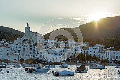 Boats in the beach and houses of the village of Cadaques, Spain Editorial Stock Photo