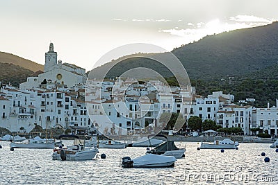 Boats in the beach and houses of the village of Cadaques, Spain Editorial Stock Photo