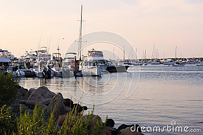 Boats on the dock at sunset Stock Photo