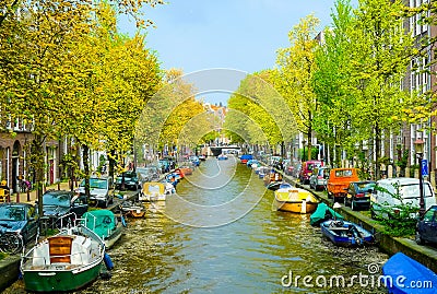 Boats and cars resting side by side in Amsterdam Stock Photo