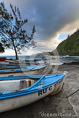 Boats and coast at Anse des Cascades near Sainte Rose city, Reunion Island Editorial Stock Photo