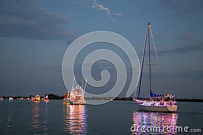 Power and Sailboats Participate in a Holida Boat Parade Stock Photo