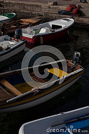 boats docked in a harbor along the coast line of a town Editorial Stock Photo