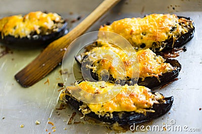 Boats of eggplant zucchini stuffed with meat, rice, tomato and mushrooms with grated cheese Stock Photo