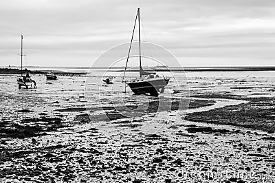 Boats on the foreshore at Lindisfarne Island, Northumberland Stock Photo