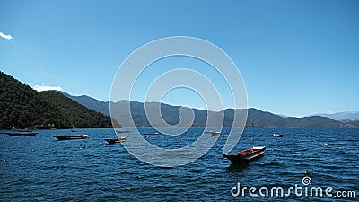 Boats in Goddes Bay of Lugu Lake Stock Photo