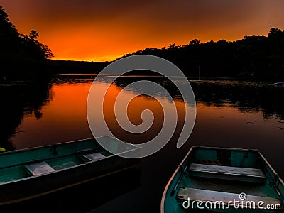 Boats on a lake at sunset Stock Photo