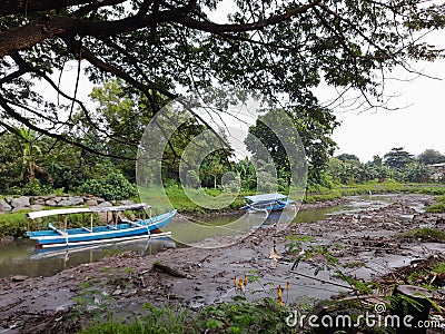 2 boats leaning on a shallow river Stock Photo