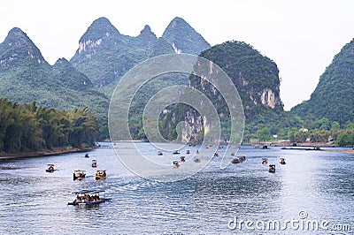 Boats and rafts on Li-River or Li Jiang, China with bizarre limestone mountains Stock Photo