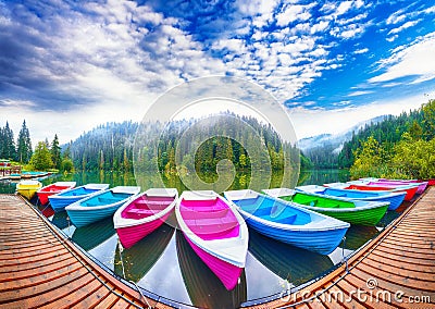 Boats on majestic mountain lake Lacul Rosu or Red Lake or Killer Lake Editorial Stock Photo