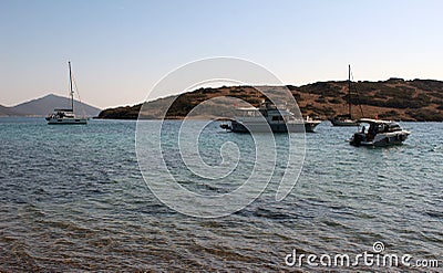 Boats moored in dark Mediterranean sea waters of the strait between Gorecek Adasi Island and the mainland. Stock Photo