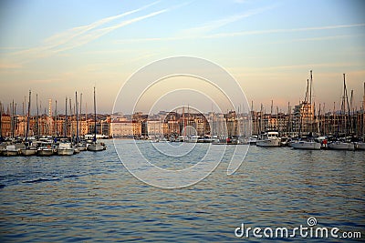 Boats moored in the harbor, illuminated by the light of sunset, Parc National des Calanques, Marseille, France Stock Photo