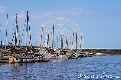 Boats moored at Morston Creek, Norfolk as the tide comes in Stock Photo