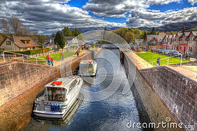 Boats moving through the lock gates on the Caledonian Canal Fort Augustus Scotland UK which connects Fort William to Inverness Editorial Stock Photo