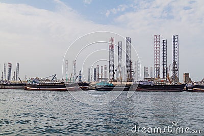 Boats, oil derricks and cranes Stock Photo