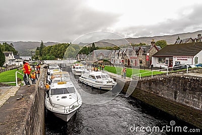 Boats parked between the locks and people waiting to enter the Caledonian Canal in Fort Augustus near Loch Ness, Scotland Editorial Stock Photo