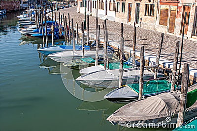 boats parking at the small pier in Burano, Venice Stock Photo