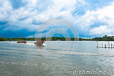 Boats with people. Madu River Safari. very beautiful blue sky. boats sailing at high speed Editorial Stock Photo