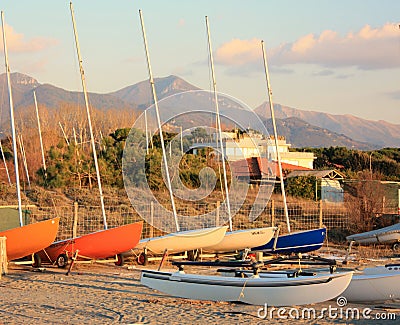 Boats resting on the beach in their parking area waiting for the summer Editorial Stock Photo