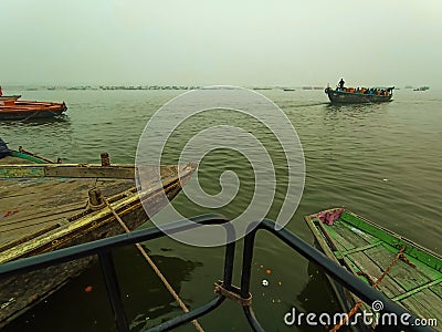 Boats at river Ganga Ghat people at holy ghats among ancient hindu temples in early morning in Varanasi Evening at Banaras Ghat Editorial Stock Photo