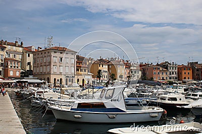 Boats in Rovinj harbor, Croatia with town behind Editorial Stock Photo