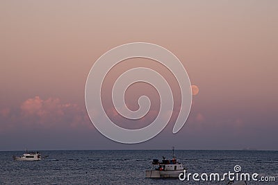 Boats in the sea during the evening in the beautiful island of Stromboli, Italy Editorial Stock Photo