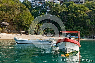 Boats tethered by scenic beach Stock Photo