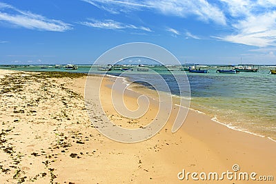 Boats on the transparent waters of Itapua beach Stock Photo