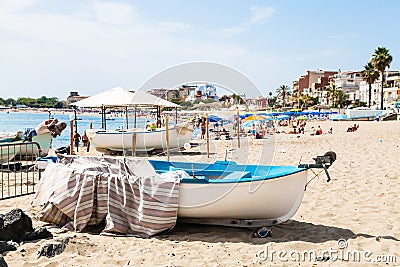 Boats on urban beach in Giardini Naxos town Editorial Stock Photo