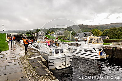 Boats waiting for locks to be opened to enter the Caledonian Canal from Loch Ness in Fort Augustus, Scotland Editorial Stock Photo
