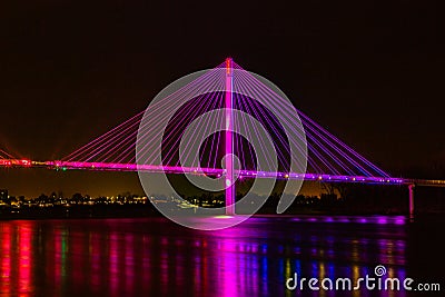 Bob Kerrey cable stayed pedestrian bridge Omaha Nebraska at night with lights reflection in the Missouri river. Stock Photo