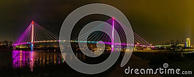 Panorama of Bob Kerrey pedestrian bridge Omaha Nebraska at night with multiple light reflections in the Missouri river. Stock Photo