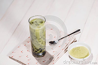 Boba / Bubble tea. Homemade Matcha Milk Tea with Pearls on wooden table. Stock Photo