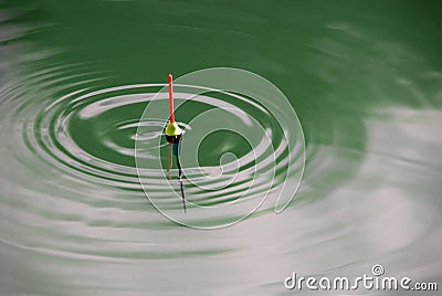 Bobber with green waves Stock Photo
