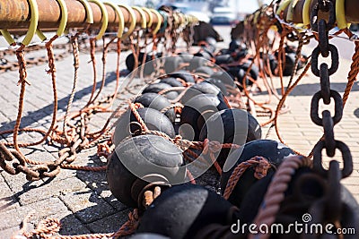 Bobbins and floats for bottom trawling with a trawl fishing net, drying on a street Stock Photo