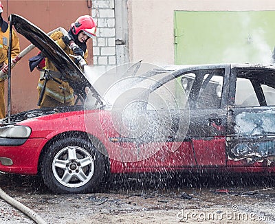 BOBRUISK, BELARUS - JULY 25, 2018: Two firemen extinguish a burning car, fire Editorial Stock Photo