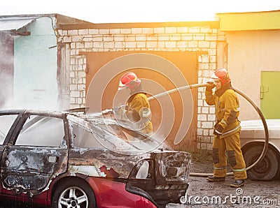 BOBRUISK, BELARUS - JULY 25, 2018: Two firemen extinguish a burning car, fire Editorial Stock Photo