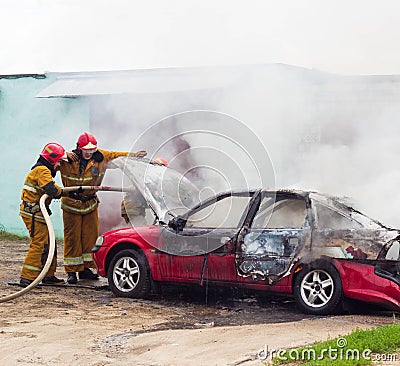 BOBRUISK, BELARUS - JULY 25, 2018: Two firemen extinguish a burning car, fire Editorial Stock Photo