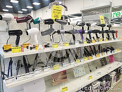 Bobruisk Belarus 19.09.2019: Sale of hair dryers and irons for hair styling in the store of household appliances and electronics Editorial Stock Photo