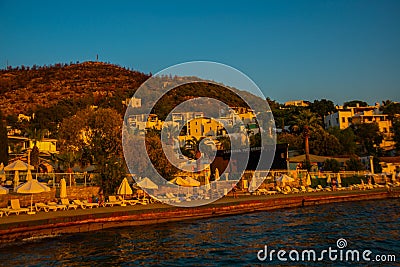 BODRUM, TURKEY: Cityscape on the boardwalk with boat view in the evening at sunset in Bodrum. Editorial Stock Photo