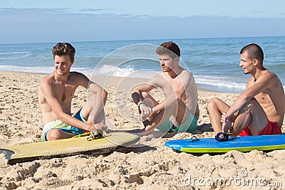 3 body board surfers relaxing Stock Photo