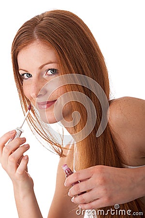 Body care - Young woman apply lipstick Stock Photo